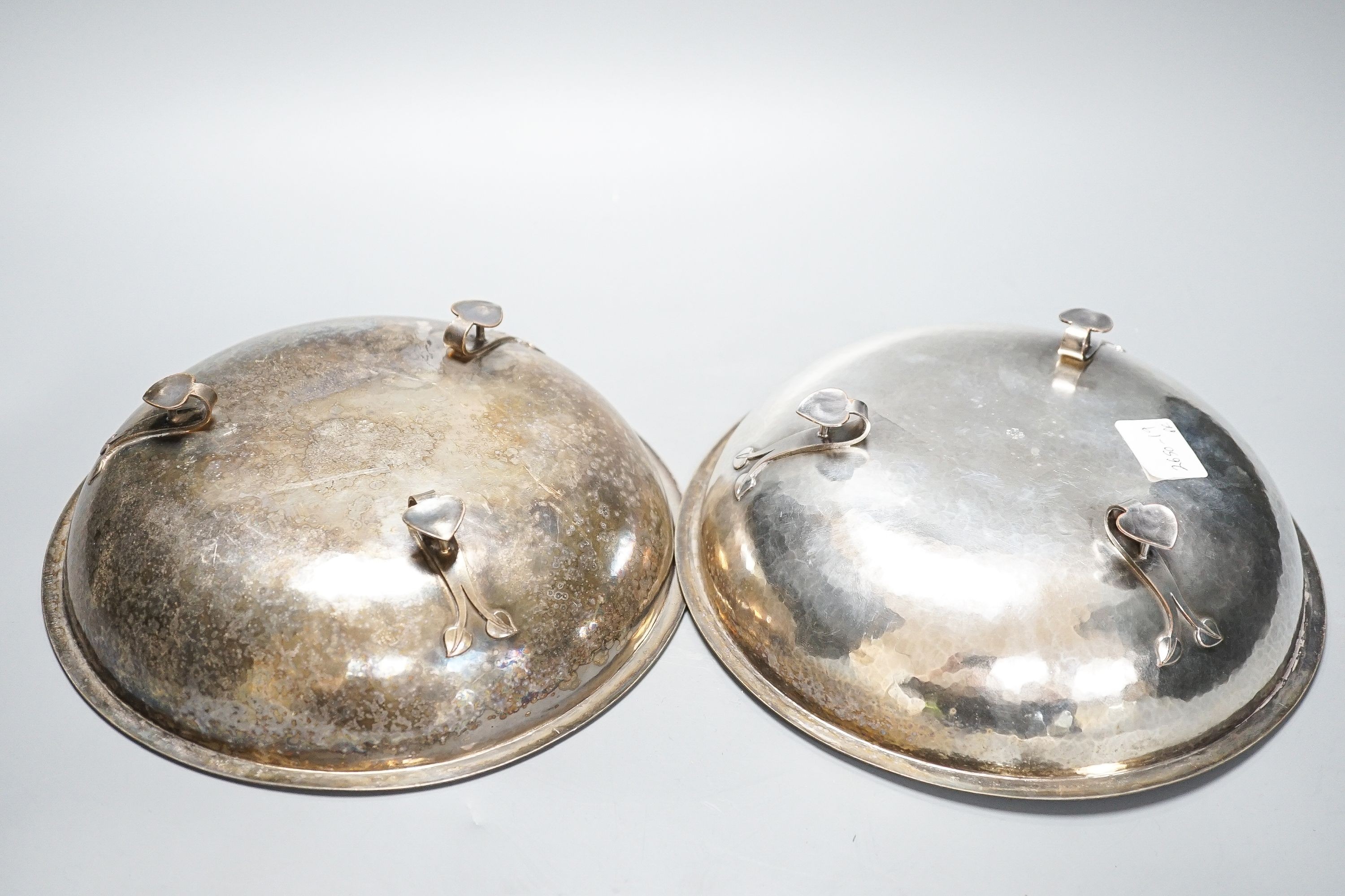 A pair of Keswick School of Industrial Arts silver plated bowls, on stylised spade feet, 23cm diameter